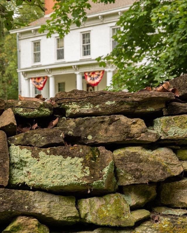 Front Stone Wall & House with Banners